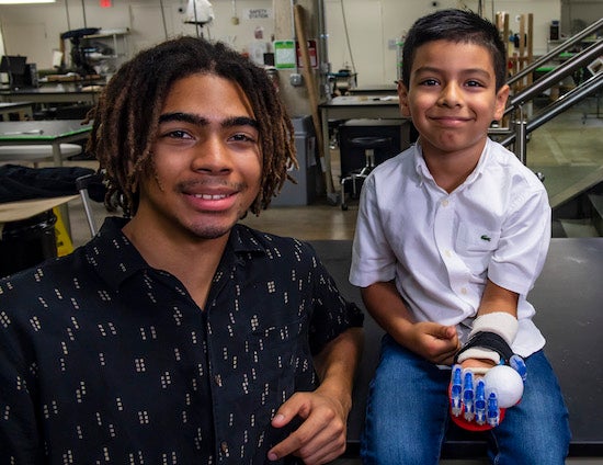 Rice University student Arinze Appio-Riley and his client, Adriel Rivas, for whom he designed and printed a prosthetic hand as part of the global e-Nable initiative. (Credit: Brandon Martin/Rice University)